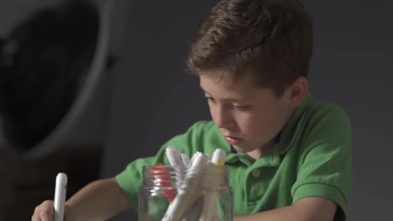 A boy draws his breakfast with a marker