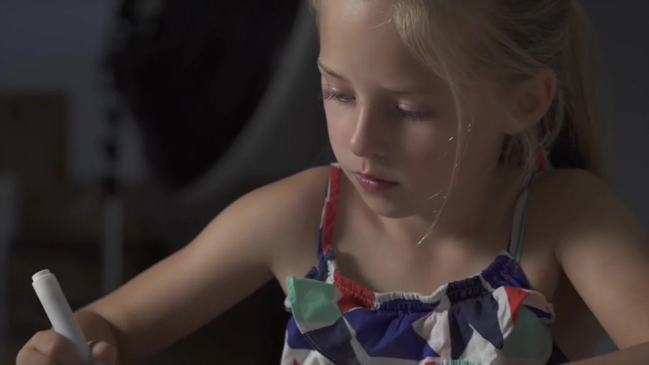 A girl concentrates on her drawing